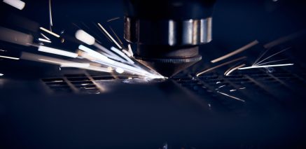 CNC Laser cutting of metal close up, modern industrial technology. Small depth of field.